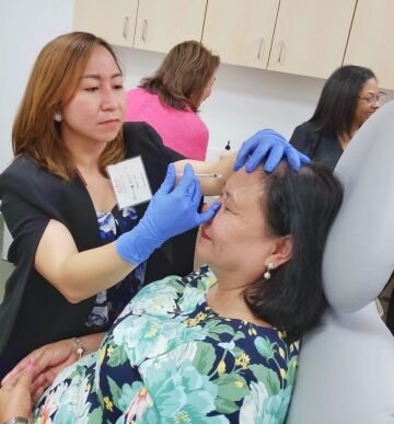 Side view of a Botox injection being administered to a live model during hands-on injector training